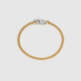 A gold-toned curb chain bracelet with a silver-toned lobster clasp, displayed on a light gray background.