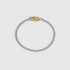 A silver-toned chain bracelet with a gold-toned lobster clasp, displayed on a light gray background.