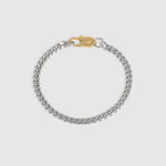 A silver-toned curb chain bracelet with a gold-toned lobster clasp, displayed on a light gray background.
