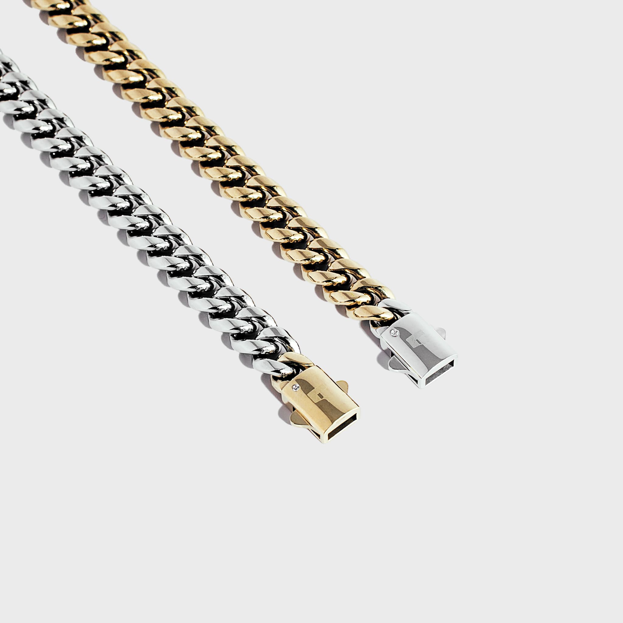 Gold chain with silver clasp and silver chain with gold clasp on a white background - side by side 