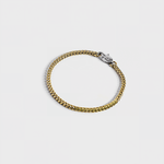 Gold chain bracelet with silver oval clasp with white background