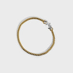 Gold chain bracelet with silver oval clasp with white background 