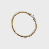 Gold chain bracelet with silver oval clasp with white background 