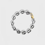 Silver mariner bracelet with gold oval clasp on white background