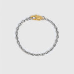 A silver-toned metal chain bracelet with a gold lobster clasp displayed on a light gray background.