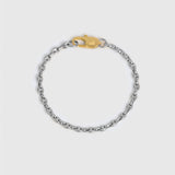 A silver-toned metal chain bracelet with a gold lobster clasp displayed on a light gray background.