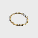 Gold mariner chain bracelet with silver oval clasp on white background
