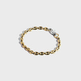 Gold mariner chain bracelet with silver oval clasp on white background

