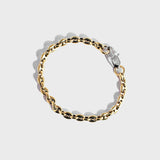 Gold mariner chain bracelet with silver oval clasp on white background
