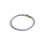 Silver mariner chain bracelet with gold oval clasp on white background