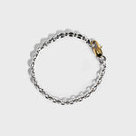 Silver mariner chain bracelet with gold oval clasp on white background