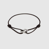 A black adjustable cord bracelet with a polished silver-toned metal interlocking hex beads, shown on a light gray background.