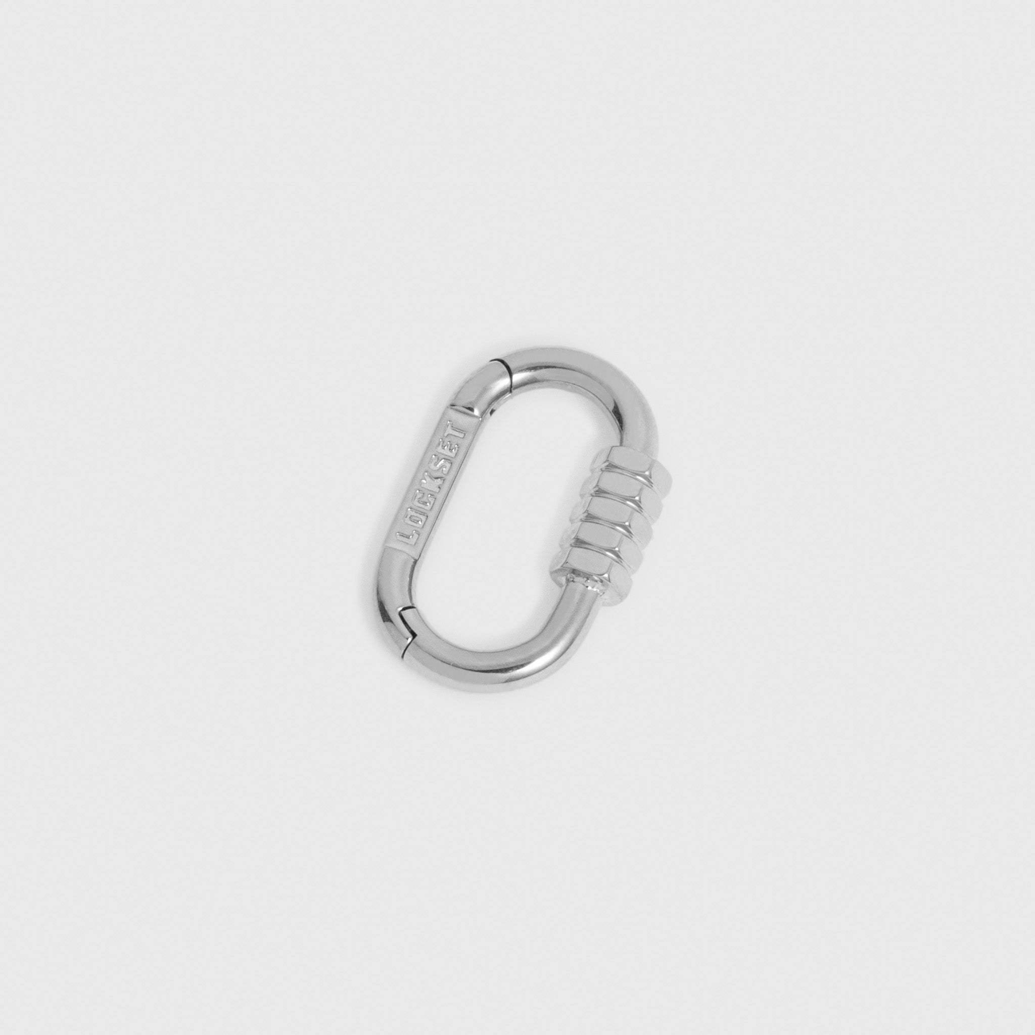 A silver metal carabiner with a textured grip on one side and the brand name Lockset engraved on the gate, shown on a light gray background.