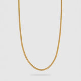 A gold chain necklace with a classic curb link design, shown hanging against a light gray background.