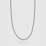 A silver-toned metal chain necklace with a classic curb link design, shown against a light gray background.