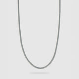 A silver-toned metal chain necklace with a classic curb link design, shown against a light gray background.