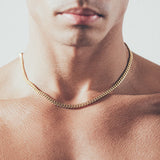 Close-up of man wearing gold Cuban chain necklace