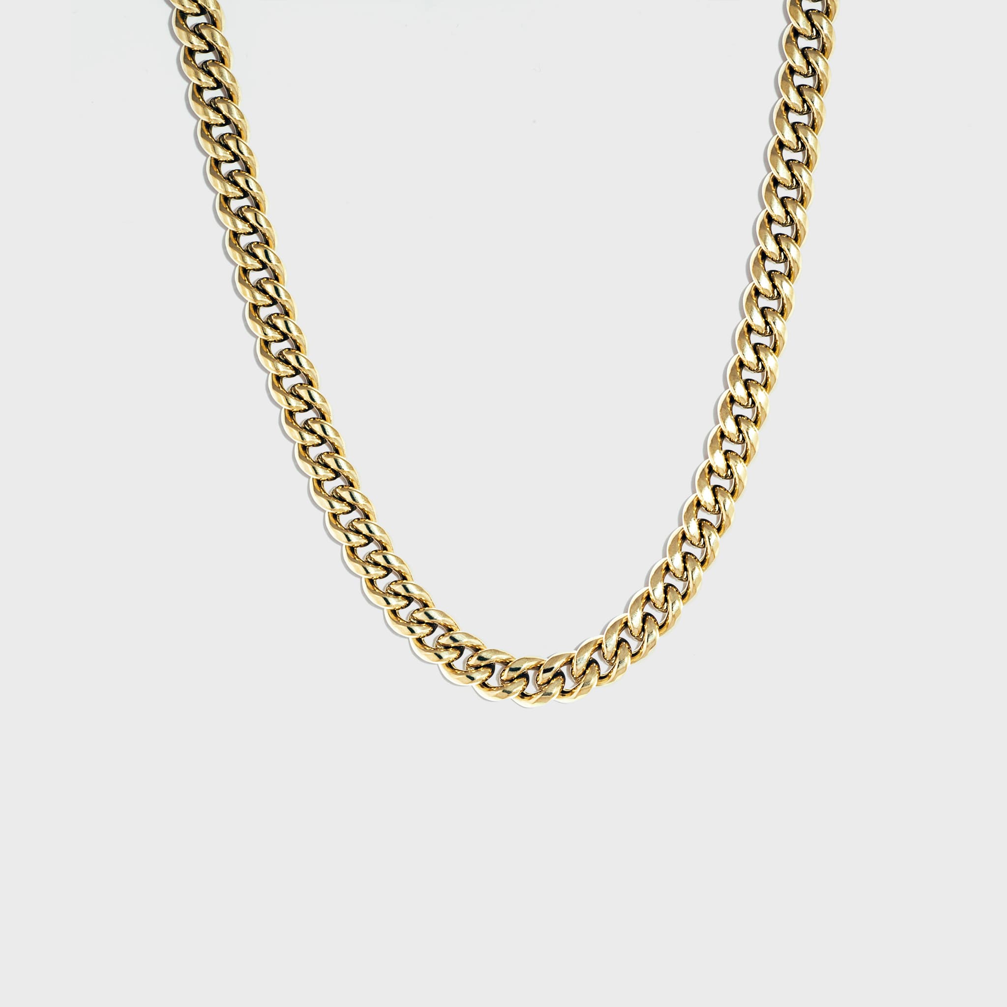 Thick gold Cuban chain on white background