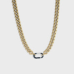Thick gold Cuban chain on white background with silver carabiner clasp