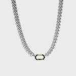 Thick silver cuban chain on white background with gold carabiner clasp 