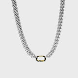 Thick silver cuban chain on white background with gold carabiner clasp 