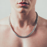 Close-up of man wearing thick silver Cuban chain necklace