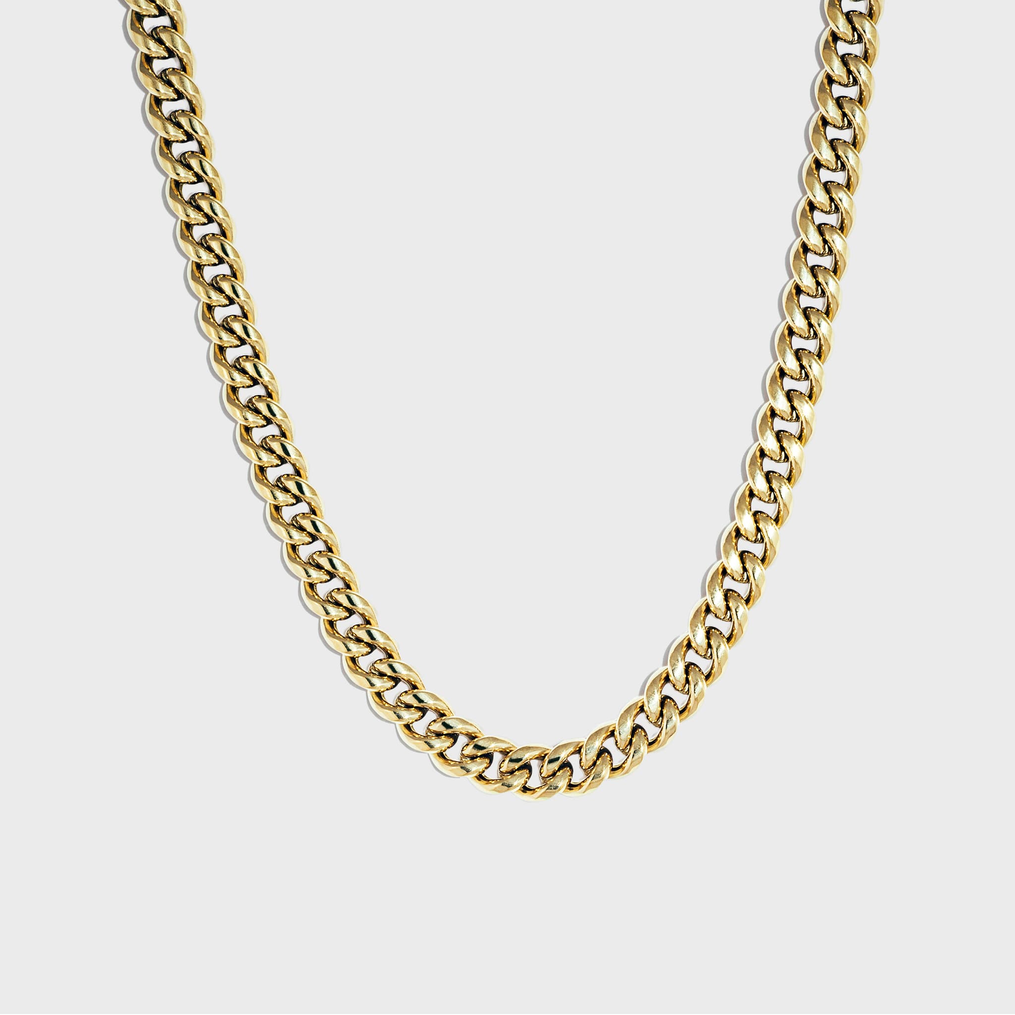 Thick gold cuban chain on white background