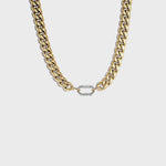 Thick gold cuban chain on white background with silver carabiner clasp