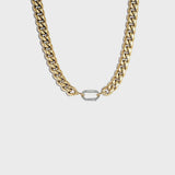 Thick gold cuban chain on white background with silver carabiner clasp