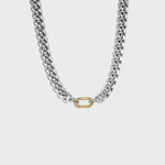 Thick silver cuban chain with gold carabiner clasp on white background