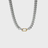 Thick silver cuban chain with gold carabiner clasp on white background