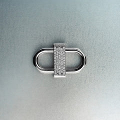 Silver double lock pendant featuring centered diamond detail on gray background