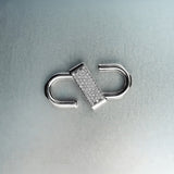 Silver double open-lock pendant featuring centered diamond detail on gray background