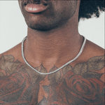 Close-up of man wearing silver chain necklace 