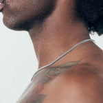 Close up of man wearing silver chain necklace