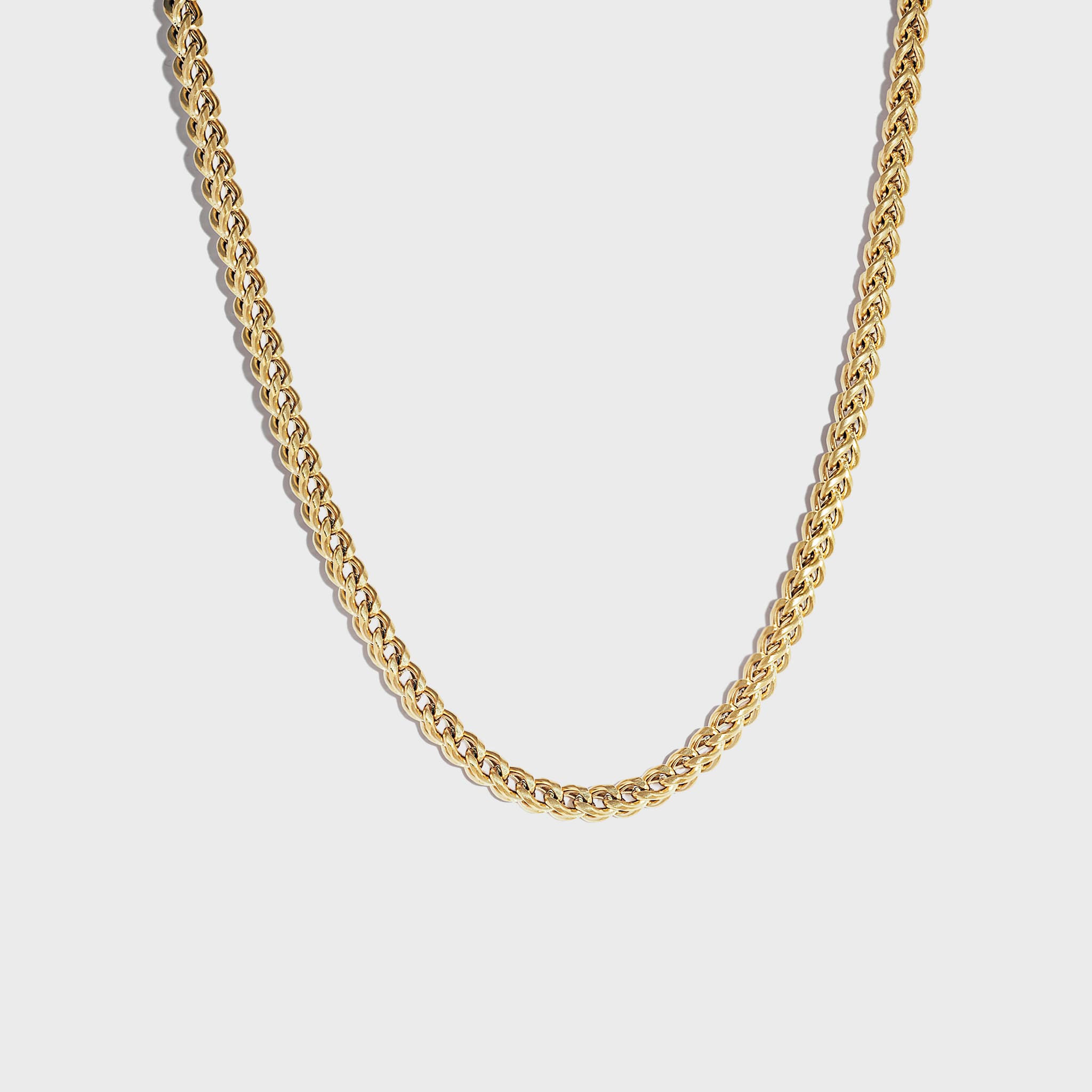 Thick gold chain on white background
