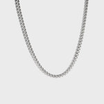 Thick silver chain necklace on white background