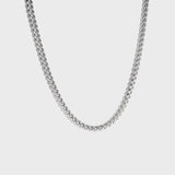 Thick silver chain necklace on white background