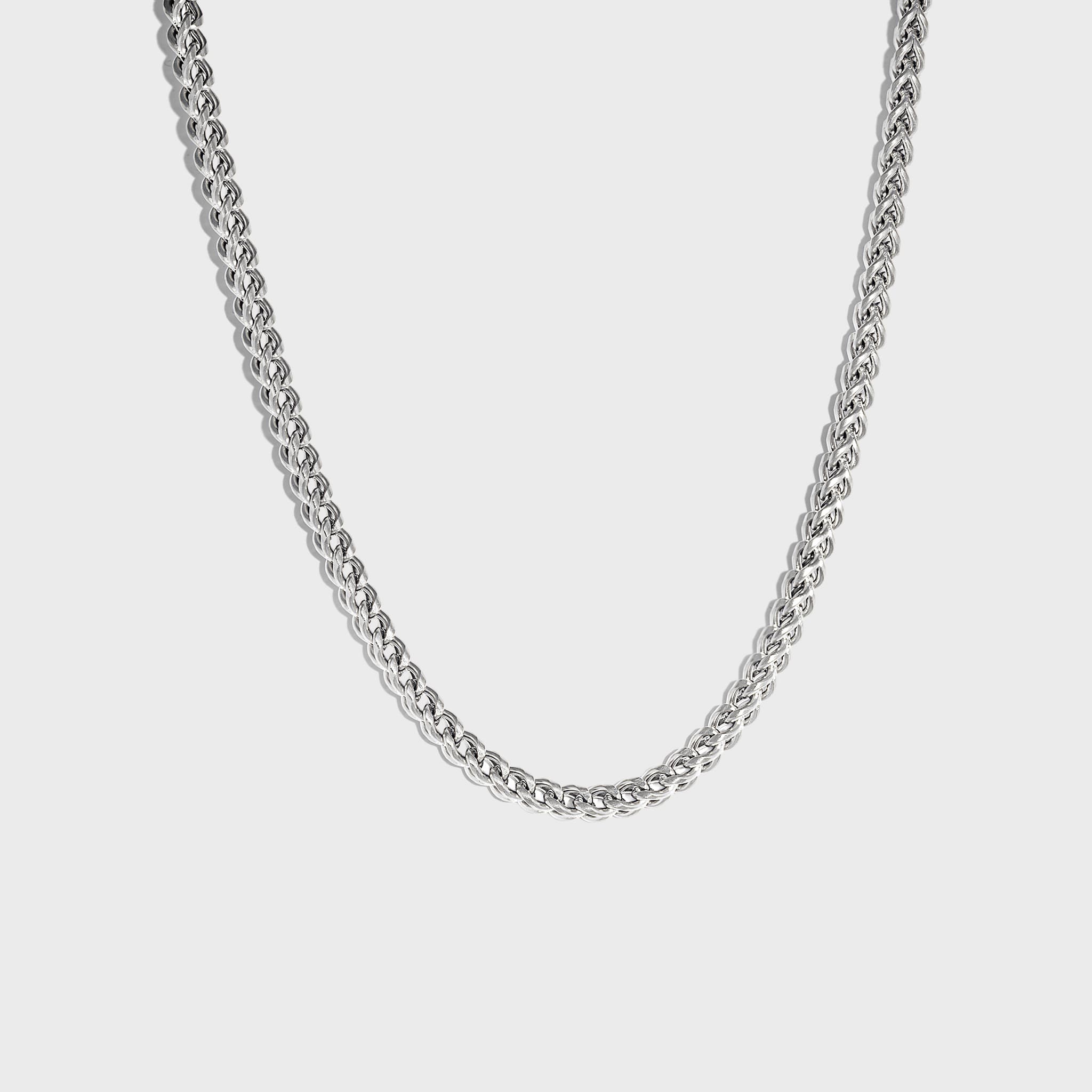 Thick silver chain necklace on white background