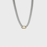Thick silver chain necklace with gold carabiner clasp on white background
