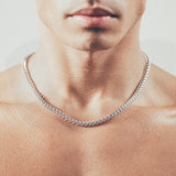 Close-up of man wearing thick silver chain necklace
