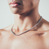 Close-up of man wearing silver chain necklace 