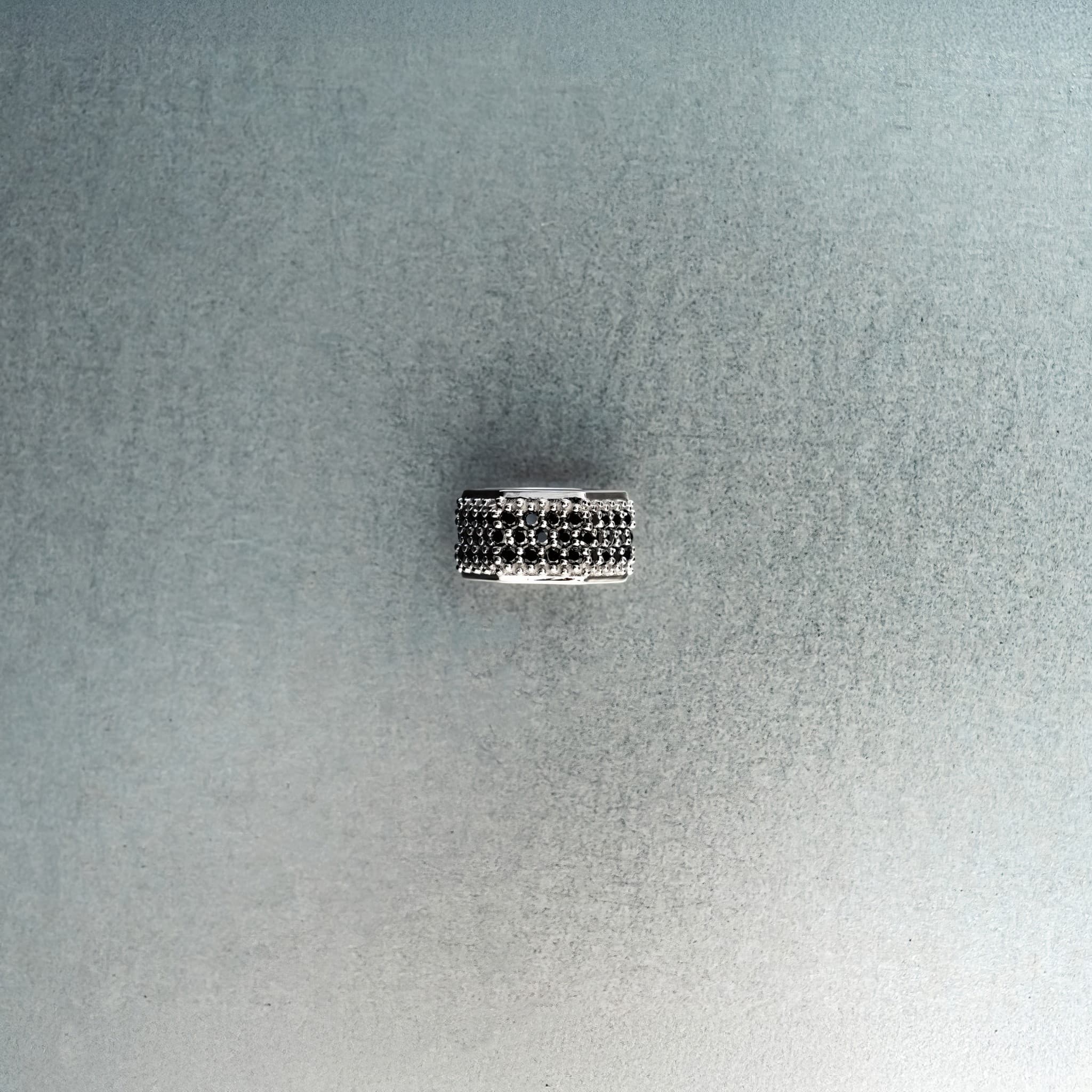 Silver hex nut bead featuring black diamond detailing on light gray background
