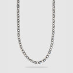 A silver-toned metal chain necklace with a washer link design, shown hanging against a light gray background.