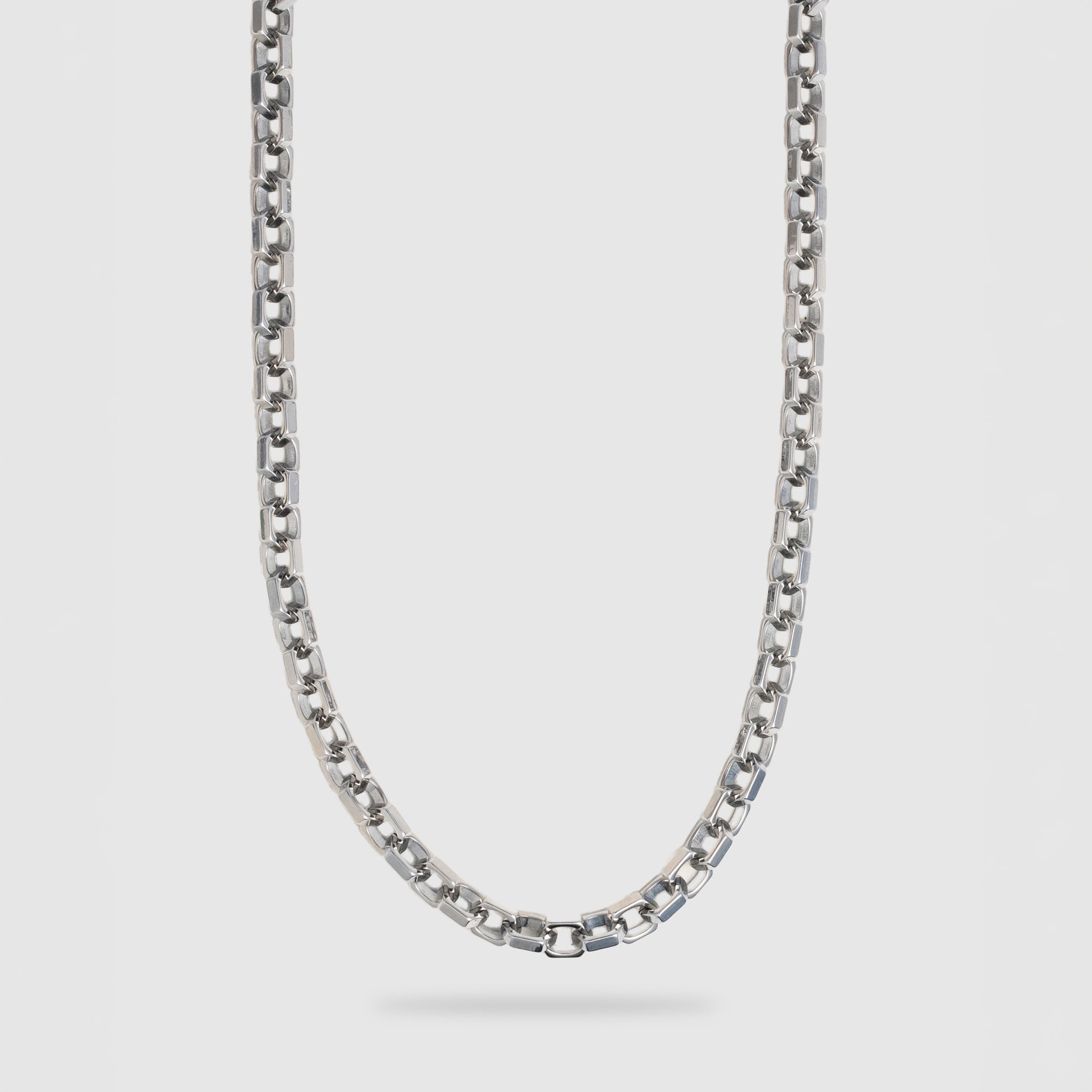 A silver-toned metal chain necklace with a washer link design, shown hanging against a light gray background.