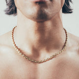 Close-up of man wearing gold mariner-link chain