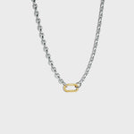 Silver mariner-link chain with gold carabiner clasp on white background