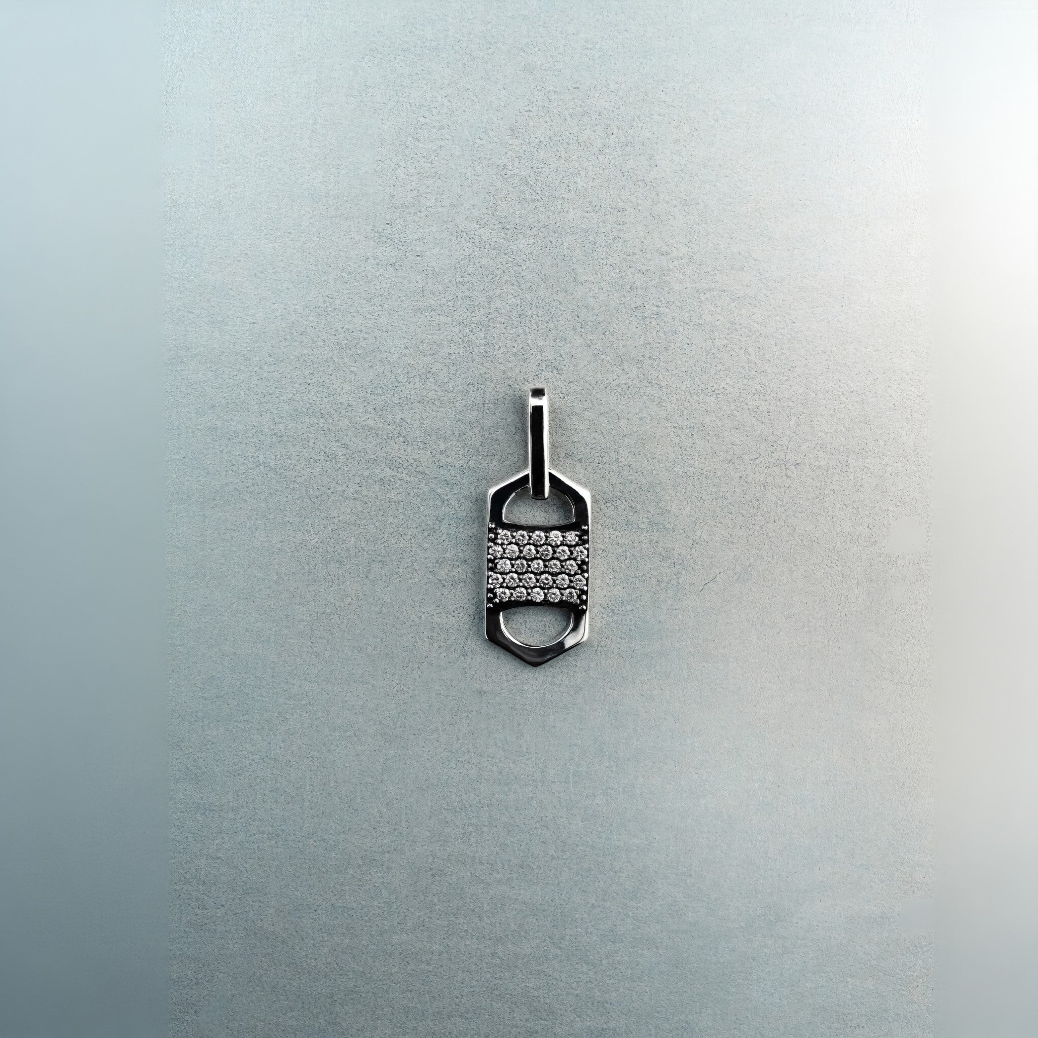 Rectangular six-sided silver tag pendant with centered diamond cluster, top and bottom cutout details