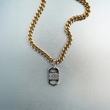 Gold chain necklace with rectangular six-sided silver tag pendant featuring centered diamond cluster and cutout detailing