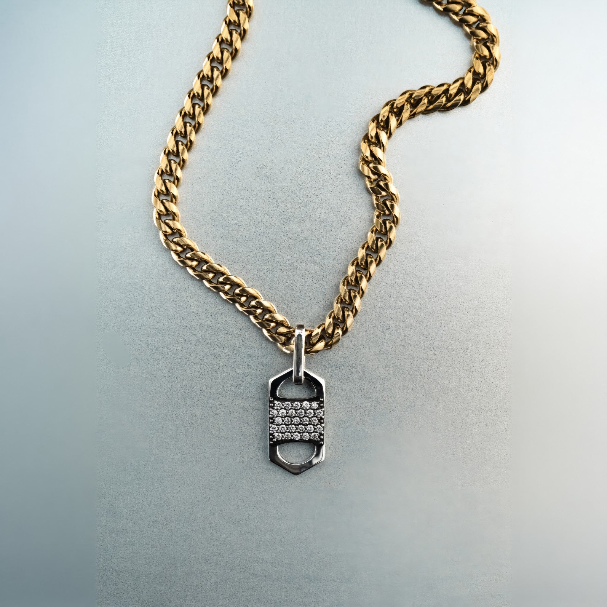 Gold chain necklace with rectangular six-sided silver tag pendant featuring centered diamond cluster and cutout detailing